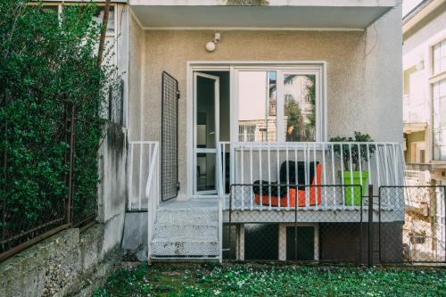 a porch with a white railing and a door at Smart hostel in Belgrade