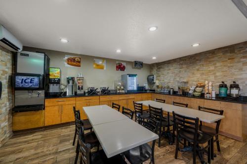 a restaurant with tables and chairs and a bar at Quality Inn JFK Airport Rockaway Blvd in Queens