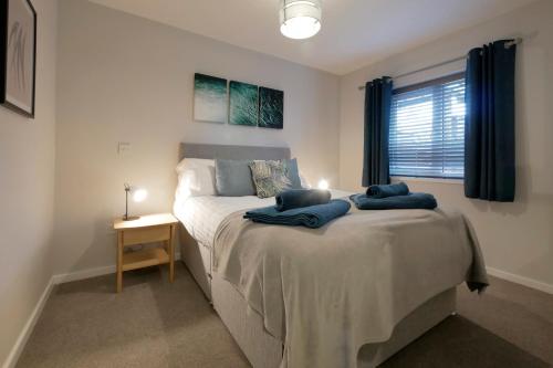 a bedroom with a bed with two pillows on it at Crewe Short Lets 6 Victoria Court, Crewe in Crewe