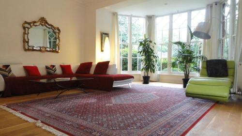 a living room with a couch and a rug at The Old Rectory Apartment in Milton Keynes