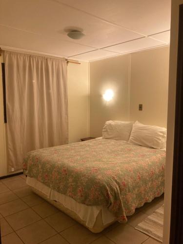 a bedroom with a large bed with white pillows at Cabañas Florencia La Serena in La Serena