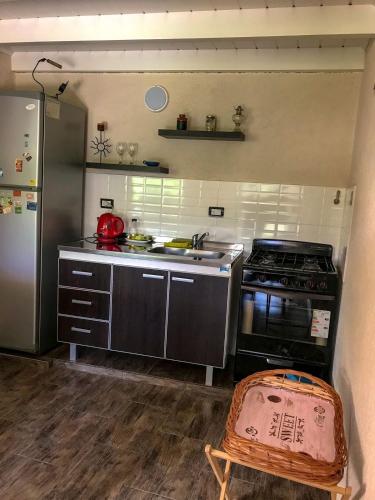 a small kitchen with a stove and a sink at Departamentos El Milagro in Tanti