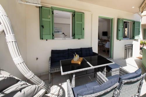 a living room with a table and chairs at Piccola Oliva in Lefkada Town