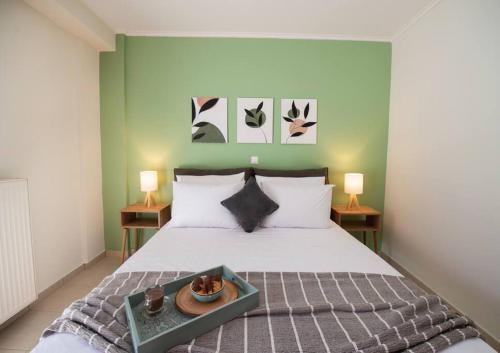 a bedroom with a bed with a tray of food on it at Piccola Oliva in Lefkada Town