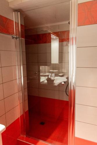 a bathroom with a shower with a sink and a mirror at Villa Cavo d' Oro in Korissia