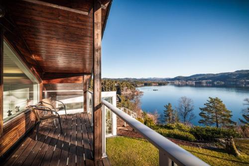 a balcony of a house with a view of a lake at Villa Arboretet - Seaside villa with private pool & infrared sauna in the heart of Arboretet, Bergen in Bergen
