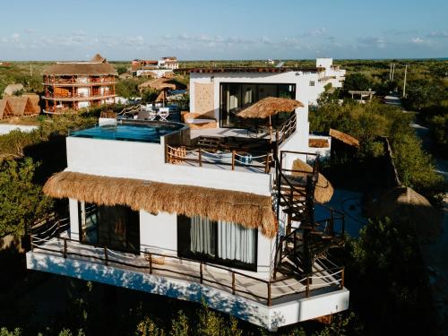 an aerial view of a house with a thatched roof at Luxury Villa Ocean View "Casa Mar" in Holbox Island
