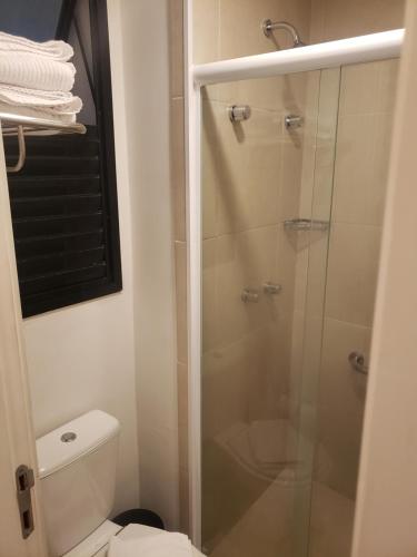 a bathroom with a toilet and a glass shower at ARTE STUDIOS in Rio de Janeiro
