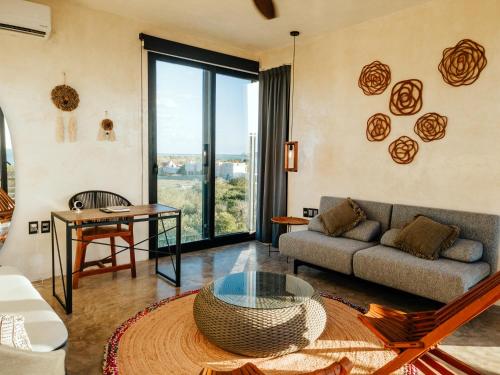 a living room with a couch and a table at Luxury Villa Ocean View "Casa Mar" in Holbox Island