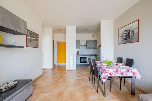 a kitchen and dining room with a table and chairs at Pretty house in Viareggio