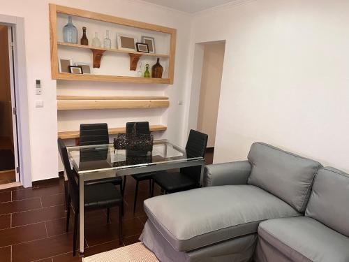 a living room with a glass table and a couch at Cantinho da Aldeia in Tomar