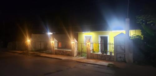 a yellow house with a gate at night at Casa los Jarochos in Valladolid