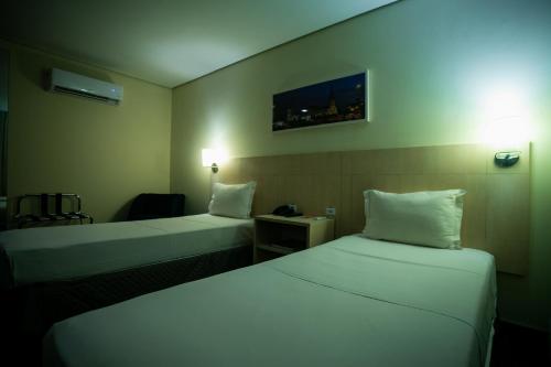 a hotel room with two beds and a table at ibis Styles Belem Batista Campos in Belém