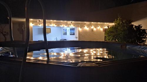 a lit up hot tub at night with lights at Casa con encanto junto a la playa de La Puntilla in El Puerto de Santa María