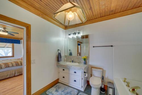 a bathroom with a sink and a toilet and a bed at Lakefront Eufaula Escape with Dock and Private Beach! in Eufaula