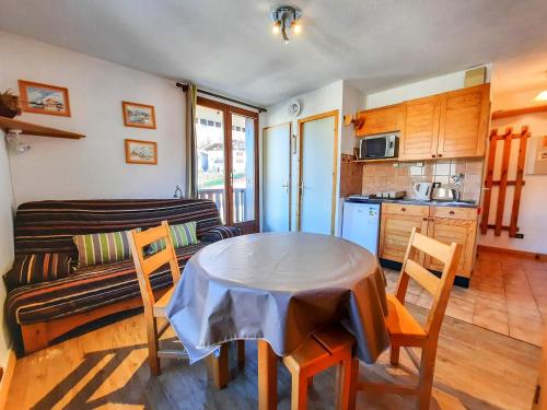 a living room with a table and a couch at Studio Saint-Martin-de-Belleville-Les Menuires, 1 pièce, 2 personnes - FR-1-452-319 in Saint-Martin-de-Belleville