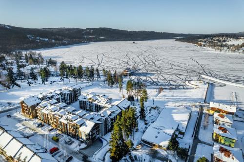 an aerial view of a building in the snow at Apartament A121 Molo Lipno s infrasaunou - Residence Koubek in Lipno nad Vltavou