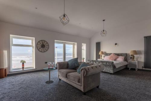 a living room with a couch and a bed at RESIDENCY LUXURY SEAFRONT HOTEL in Blackpool