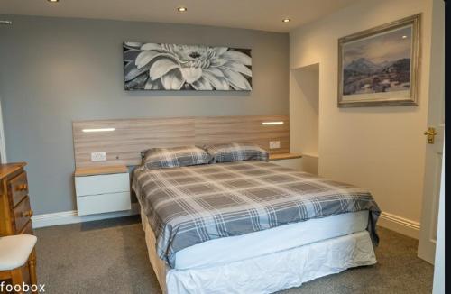 a bedroom with a bed and a painting on the wall at Weymouth Bay Hotel in Weymouth