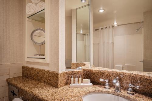 a bathroom with a sink and a mirror at Lady Luck Casino Black Hawk in Black Hawk