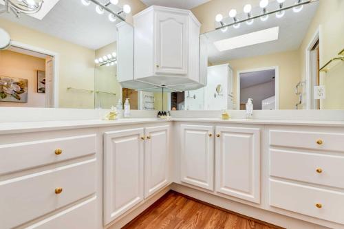 a bathroom with white cabinets and a large mirror at Stunning Maggie Valley Getaway with Decks, Fire Pit! in Maggie Valley