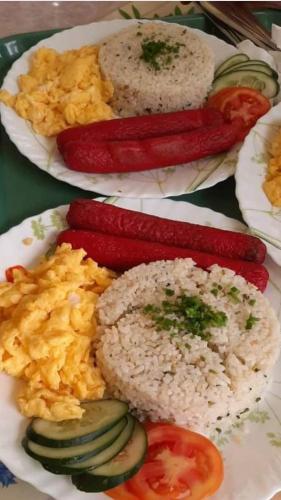 a plate of food with rice and vegetables on it at Binalonan Transient/GUESTHOUSE (PENSION GLAYDIE) in Binalonan