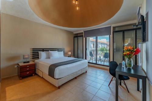 Habitación de hotel con cama y escritorio con sidra de mesa en Hotel Brisas 5a AV, Playa del Carmen, en Playa del Carmen