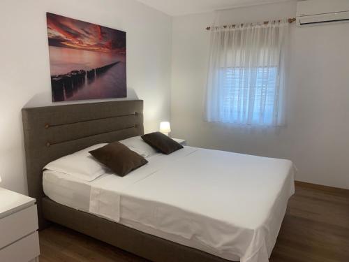 Ένα ή περισσότερα κρεβάτια σε δωμάτιο στο Apartmani Vera