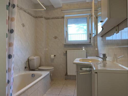 a bathroom with a tub and a toilet and a sink at Large Room Free Parking 10mins to Luxembourg Airport Excellent Customer Service in Luxembourg