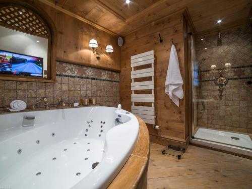 a large bathroom with a tub and a tv at Luxueux Duplex 4* avec parking privé au cœur de Courchevel 1850 - FR-1-575-15 in Courchevel
