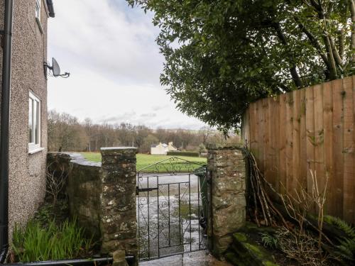 an iron gate to a garden with a fence at Pippins in Bream