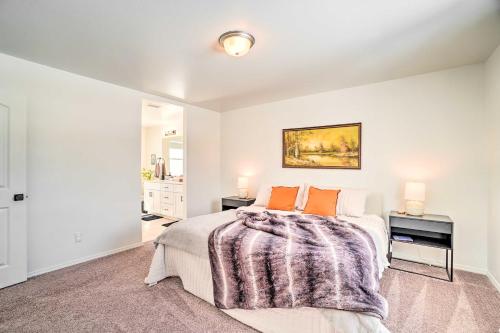 a bedroom with a bed and a table with two lamps at Family-Friendly Home about 12 Mi to Downtown Flagstaff in Bellemont