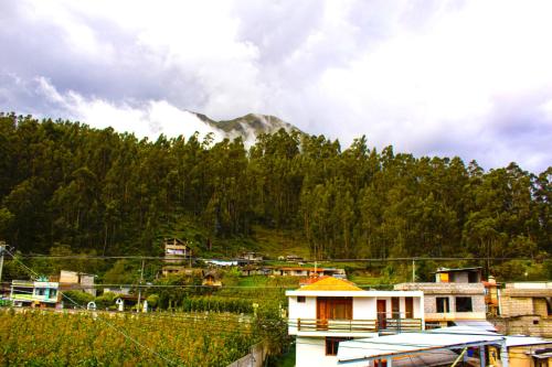 a small village with a mountain in the background at Casa de Luis in Otavalo