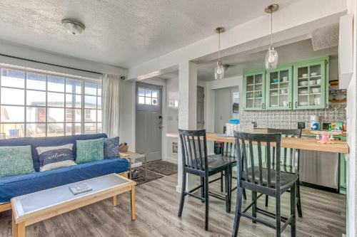a living room with a blue couch and a kitchen at Cake by the Ocean in Lincoln City