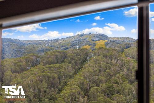 a view of a mountain from a train window at Mowamba E5 in Thredbo