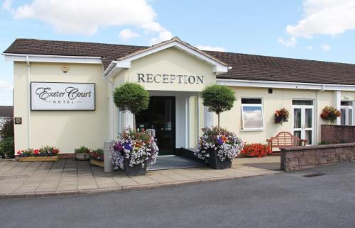 a white building with flowers in front of it at Exeter Court Hotel in Exeter