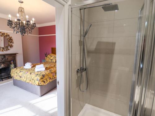 a bathroom with a shower and a bed at 105 Spilsby Road in Boston