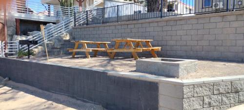a wooden picnic table sitting next to a brick wall at Couples getaway in Bullhead City