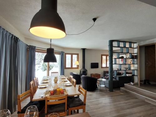 une salle à manger et un salon avec une grande table dans l'établissement Chalet lumineux 3* proche lac et pistes, calme, 80m VTT/ski, 2 parkings, WiFi, équipé pour 10 pers. - FR-1-598-87, aux Gets
