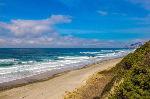 a sandy beach with the ocean in the background at A Slice Above in Lincoln City