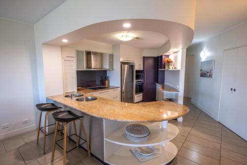 a kitchen with a island in the middle of a room at Pavillions on 1770 in Agnes Water
