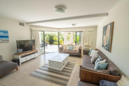 a living room with a couch and a tv at Pavillions on 1770 in Agnes Water