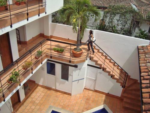 a woman walking down the stairs of a house at Chrisban Hotel Boutique in Buga