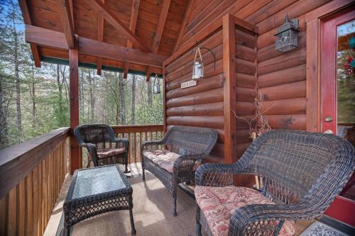 a porch of a cabin with chairs and a couch at Sylva Serenity in Sylva