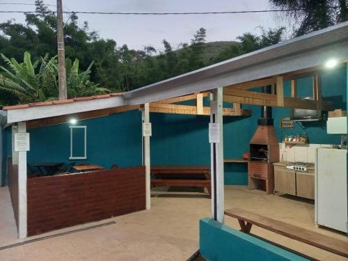 a view of a kitchen from the patio of a house at Suites Chacara Madu in Santo Antônio do Pinhal