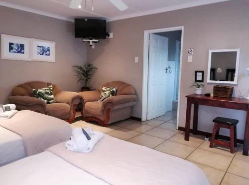 a hotel room with two beds and a tv at Tropical Seaside Suite 8 in East London
