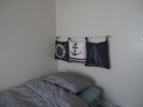 a bedroom with a bed and pillows on a wall at Wolseley the heart of the city ! in Winnipeg