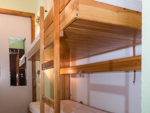 a bunk bed in a room with wooden bunk beds at Studio Villard-de-Lans, 1 pièce, 4 personnes - FR-1-515-136 in Villard-de-Lans