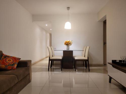 a living room with a dining room table and chairs at Apartamento em Niterói - Boa Viagem in Niterói