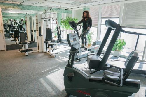 a woman standing on a treadmill in a gym at Four Sails Resort in Virginia Beach